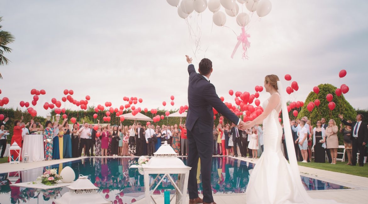 photo of a man and woman newly wedding holding balloons
