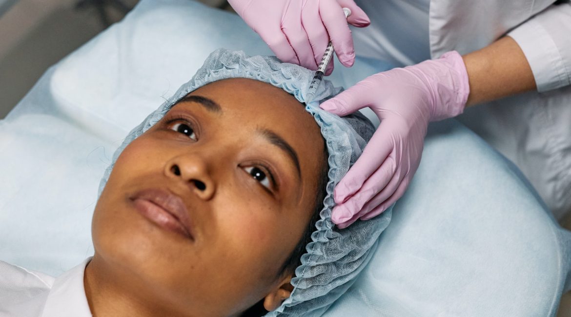 Dermatologist Injecting Botox on Client's Forehead