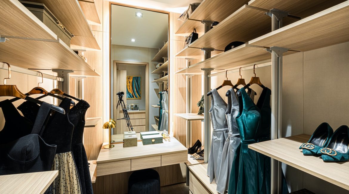 Dresses hung on brown wooden cabinet