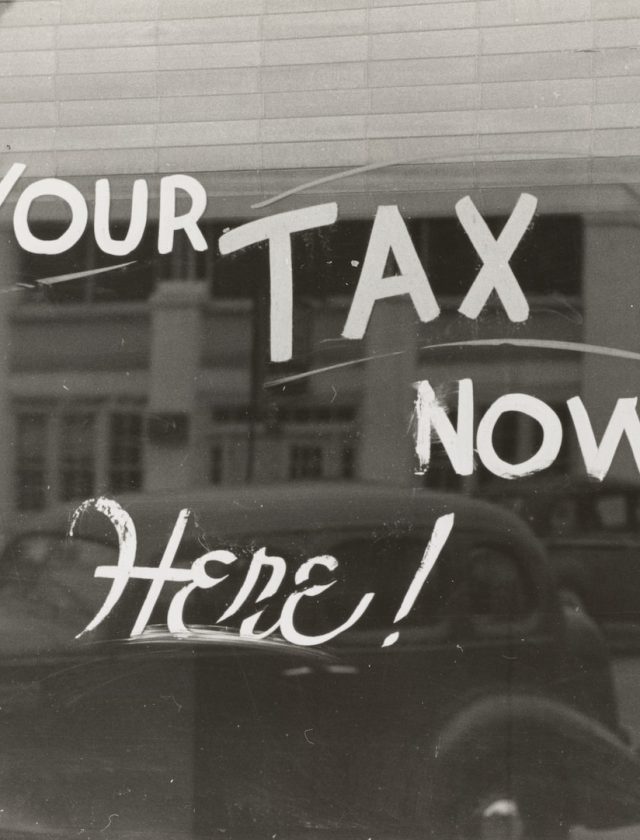 a sign that says pay your tax now here