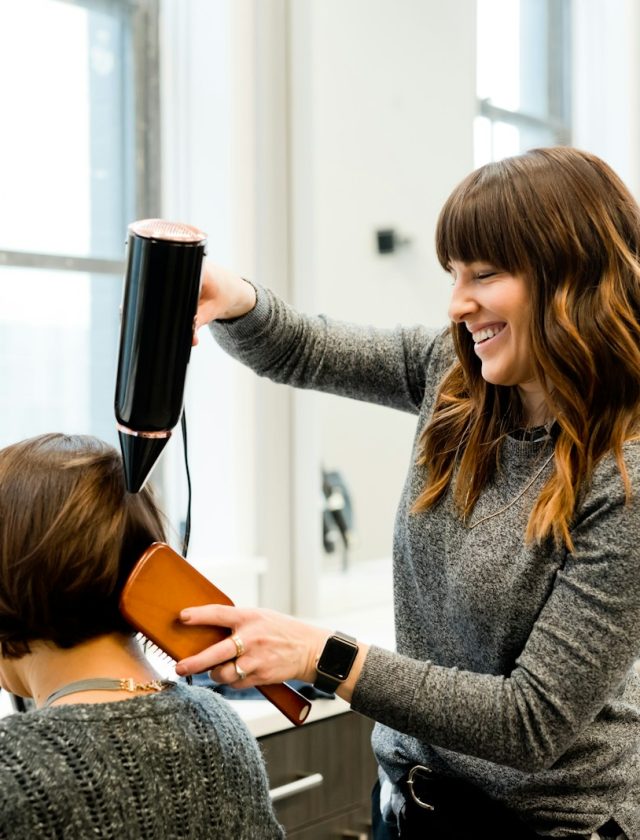 woman holding hair dryer